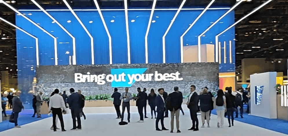 Visitors in front of the SAP booth at SAP Sapphire 2024 with the slogan Bring out your best